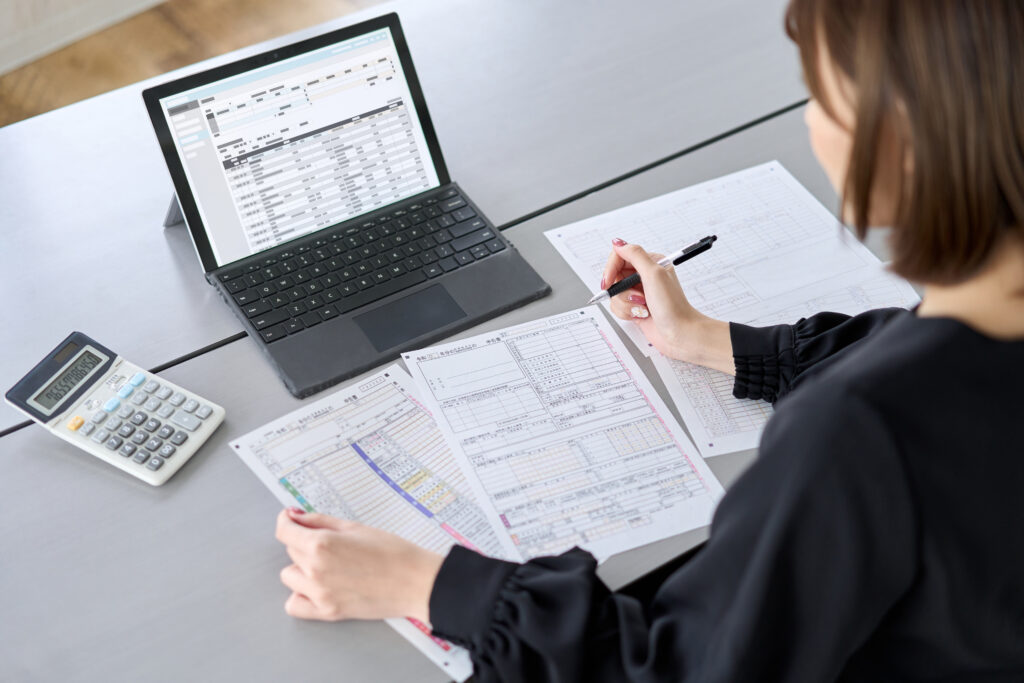 Expense-tracking. Asian woman preparing tax return documents